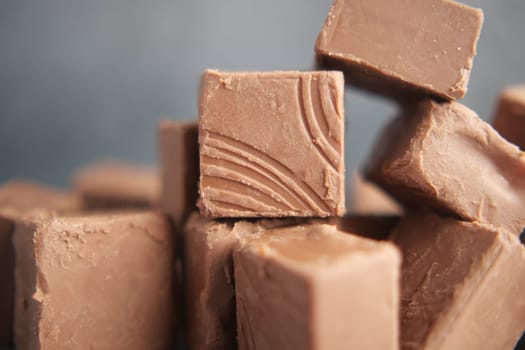 Assorted chocolate fudge squares stacked together in a tasty display.