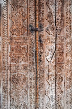 traditional Uzbek carved pattern on vintage wooden door in Tashkent in Uzbekistan