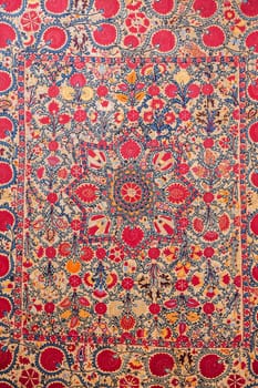 traditional Uzbek asian pattern on an ancient handmade carpet in Uzbekistan. Oriental background with beautiful ornaments