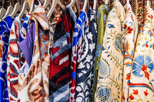 traditional festive Uzbek colorful dresses, costumes and robes at the oriental market in Uzbekistan