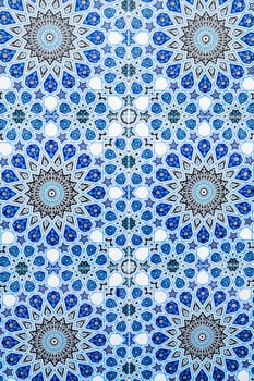ceramic tiles with a traditional Uzbek oriental pattern in Uzbekistan. Blue decorative background with Islamic ornament