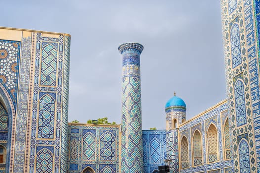 Beautiful Muslim mosque decorated with patterns with traditional oriental Uzbek Islamic ornaments in Uzbekistan