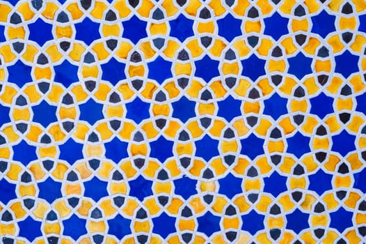 yellow and blue ceramic tiles with abstract geometric pattern. Background with uzbek ornament