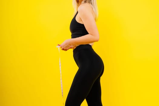 Fitness and sport concept. Portrait of a smiling young woman wearing sportswear posing isolated
