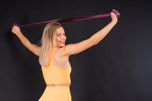 Fitness and sport concept. Portrait of a smiling young woman wearing sportswear posing isolated