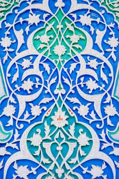 colorful carved wooden painted background with traditional Uzbek ornaments and oriental patterns in Tashkent in Uzbekistan