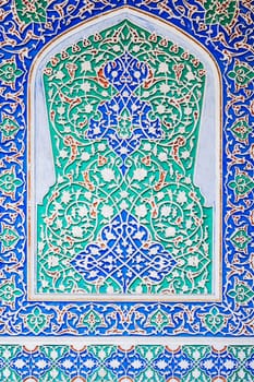 beautiful carved wooden painted background in Museum of Art of Uzbekistan with traditional Uzbek ornaments and colorful oriental patterns in Tashkent