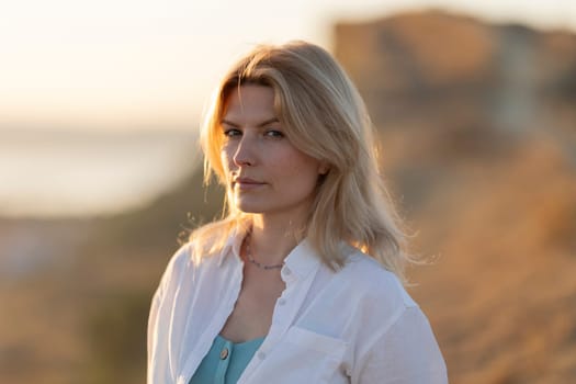 Portrait of confident businesswoman enjoying golden hour light in nature