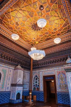 interior with painted wooden carved ceiling and walls in Museum of Art of Uzbekistan with traditional Uzbek patterns and oriental ornaments in palace in Tashkent