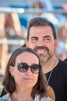 Confident man and woman in colorful outfits and matching glasses captured in an outdoor environment. Vibrant, contemporary, and full of character.