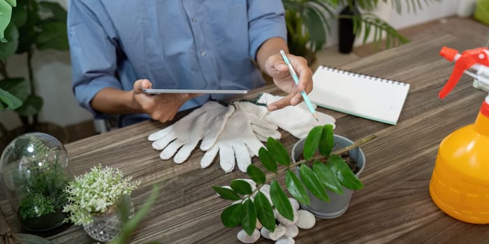 A gardener organizes tools and takes notes on plant care, demonstrating a commitment to sustainable practices in their gardening journey.