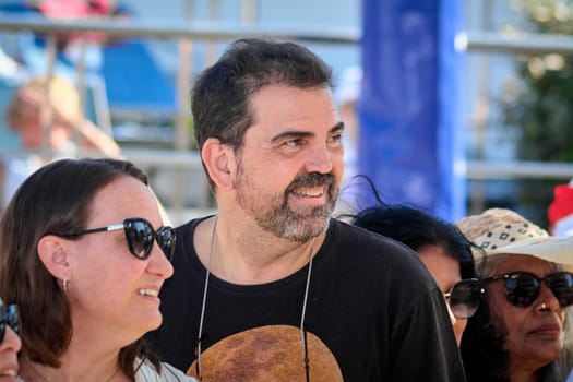 Catania. Italy - March 13, 2025: Casual outdoor gathering where friends are enjoying each other's company. The scene is filled with energy and laughter, highlighting a fun and friendly atmosphere.