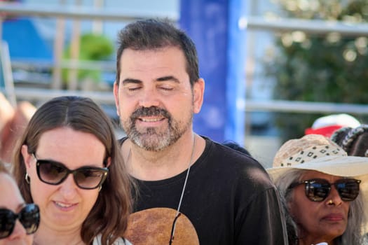 Catania. Italy - March 13, 2025: A cheerful group of people gathered in an outdoor setting, dressed casually and interacting in lively conversation. The atmosphere reflects joy, bonding.