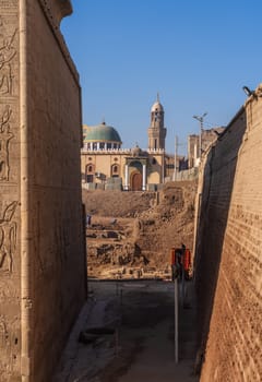 Esna, Egypt - 3 November 2024: Archeaologists dig around the well-preserved facade of the Temple of Esna