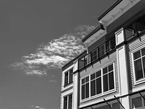 Top of residential building on cloudy sky background on a bright sunny day.