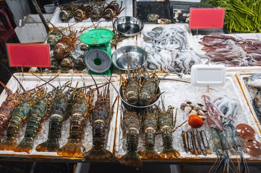 fresh lobsters and seafood on the counter at the Asian night Food market in Vietnam in Asia