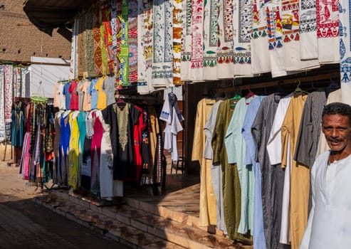 Esna, Egypt - 3 November 2024: Vibrant clothing and textile shop showcasing traditional attire and souvenirs.