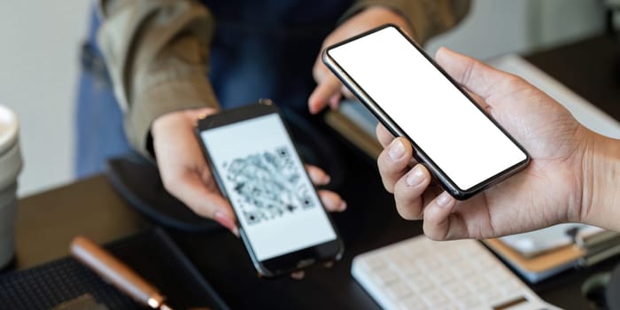 In a modern cafe, a customer engages in a seamless digital payment process, showcasing the blend of technology and eco-friendly practices.