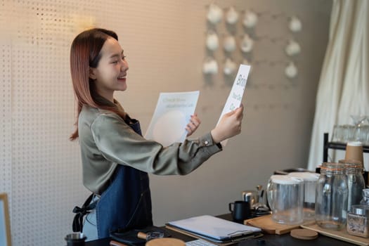 A barista beams as she holds up a sign promoting eco-friendly practices, reinforcing the cafe commitment to sustainability.