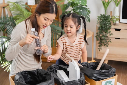 During a home activity, a mother and child sort recyclable items together, laying the foundation for environmental awareness from a young age.