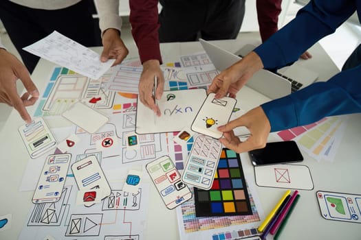 A group collaborates on refining design elements, emphasizing effective user interaction and visual clarity. Each input contributes to the overarching design vision.