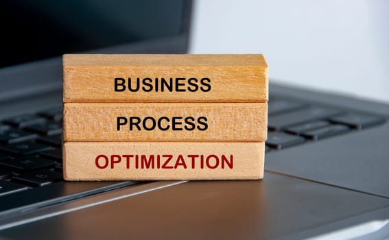 Business Process Optimization text on wooden blocks representing continuous improvement in business strategy.