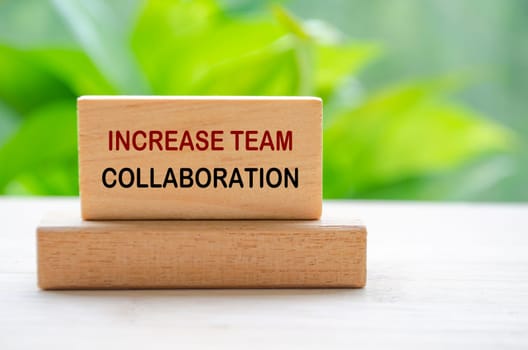 Increase Team Collaboration text on wooden blocks representing team work improvement