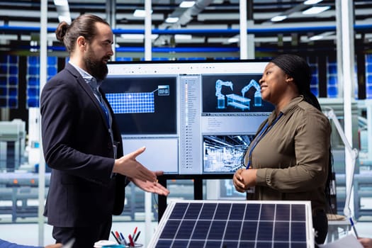 Photovoltaics factory manager meeting with shareholder to discuss business operations and growth plans. Solar panels plant management executive talking with investor, doing deal evaluation