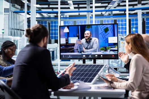 Factory researchers talk about new photovoltaics materials in online videocall. Businessmen in solar panel manufacturing plant discussing about newly developed prototypes during teleconference meeting