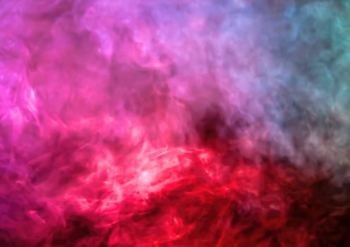 Vibrant and colorful abstract smoky background with red, pink, purple, and blue hues blending together in a dynamic display.
