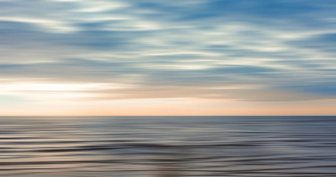 Abstract view of the sea and clouds in motion blur style . Pastel, dreamy scene.