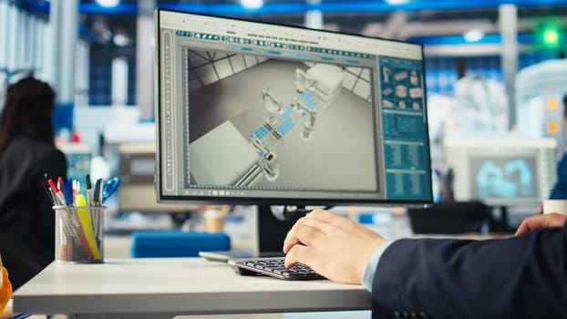 Photovoltaics factory engineer using program on PC to improve solar panels efficiency. Solar panels manufacturing plant worker researching cheaper solar solutions using computer, camera A close up