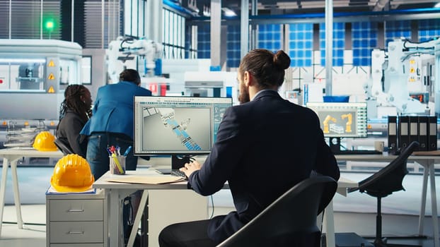 Photovoltaics factory expert looking over specifications on documents to ensure robot arms placing solar panels on assembly lines are running optimal. Specialist reads solar plant machinery paperwork