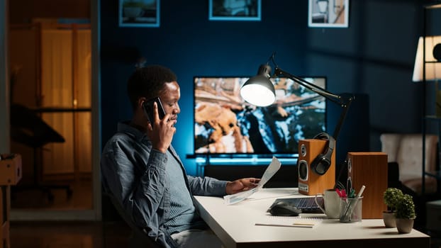 Male freelancer calling financial expert at home to discuss about monthly funds balance, increase profit with global investments. Young guy talking to advisor about capital resources. Camera B.