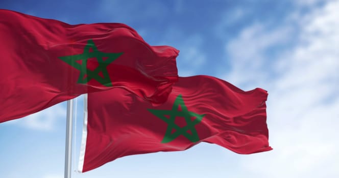 Morocco national flags waving in the wind on a clear day. Red flag with a green pentagram in the center. 3d illustration render. Rippled fabric. Selective focus
