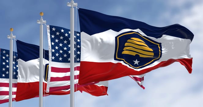 The Beehive Flag of Utah and the american flag waving on a clear day. 3d illustration render. Rippled fabric. Selective focus