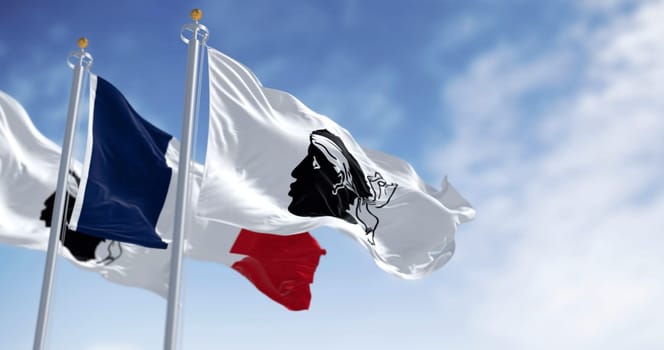 Flags of Corsica waving with national french flag on a clear day. Black Moor head with a white bandana on a white field. French region. 3d illustration render. Rippled fabric. Selective focus