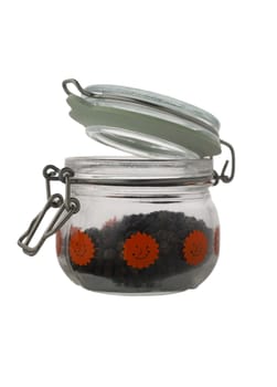 A charming glass jar featuring vibrant smiley stickers is partially open, revealing an assortment of colorful, delightful contents inside. Perfect for a playful kitchen decor idea.