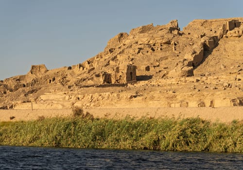 Excavations of ancient buildings by River Nile upstream from Edfu on riverbank