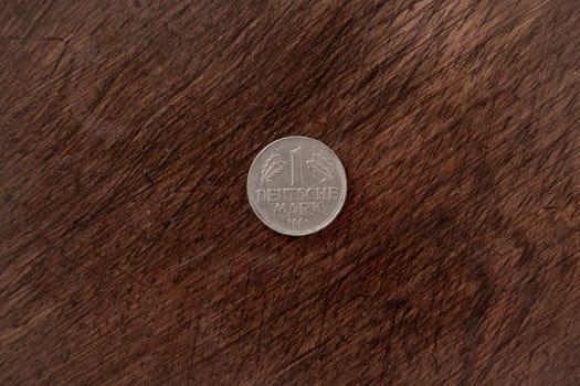 Old vintage German coin on wooden background with copy space