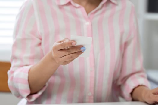 In her home office, a woman expertly handles important financial documents, emphasizing the importance of attention to detail.