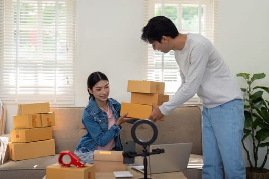 An enthusiastic entrepreneur checks her inventory while her colleague assists with packing. The image embodies teamwork and modern entrepreneurship in a cozy workspace.