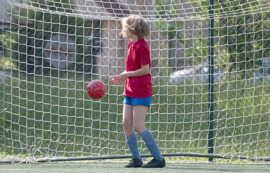 Girl Goalkeeper Stands At Goalposts During Children'S Football Match