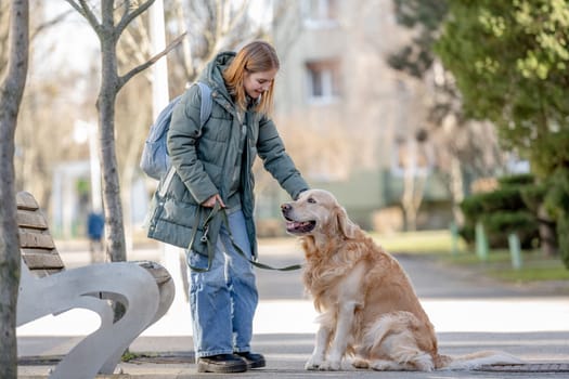 Golden Retriever Gives Paw To Its Young Girl Owner During Winter Walk With Dog