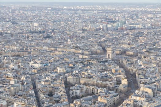 Paris city panorama with Arc de Triomphe, the aerial view from the Eiffel tower in soft evening light in early spring