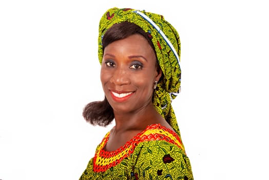 beautiful African adult woman dressed in green loincloth is smiling.
