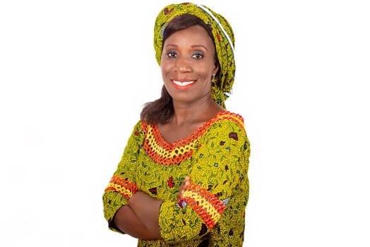 beautiful African adult woman dressed in green loincloth is smiling while crossing her arms