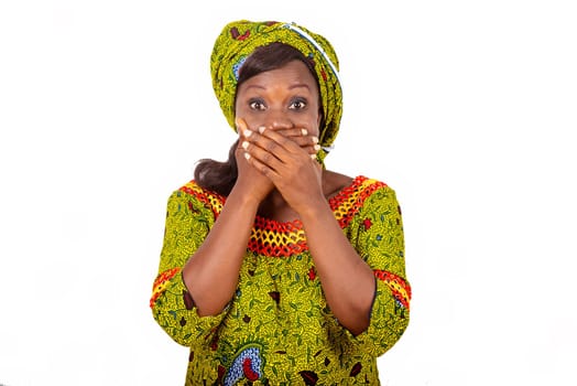beautiful african adult woman wearing a green loincloth closing her mouth with both hands