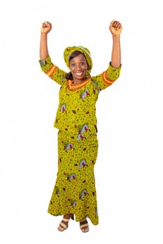 beautiful african adult woman under a magnificent suit of green loincloth is all joyful by raising both arms above her head