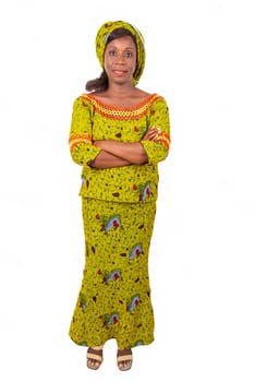 beautiful african adult woman wearing a green loincloth standing arms crossed and smiling.